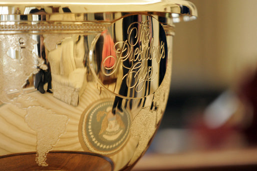 Presidents Cup golf trophy reflecting the Presidential Seal in the Oval Office